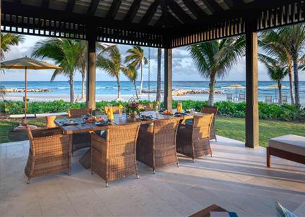 A table set up on a patio overlooking a beach