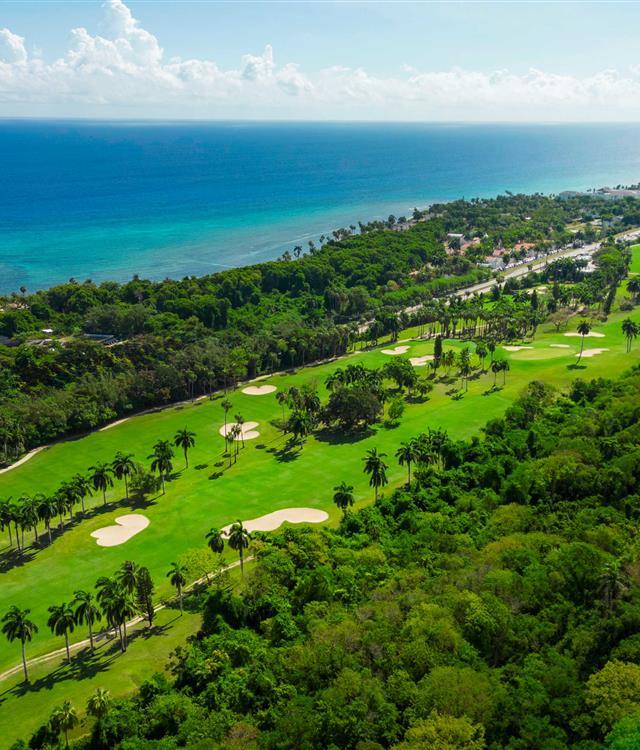 A couple of men walking on a golf course