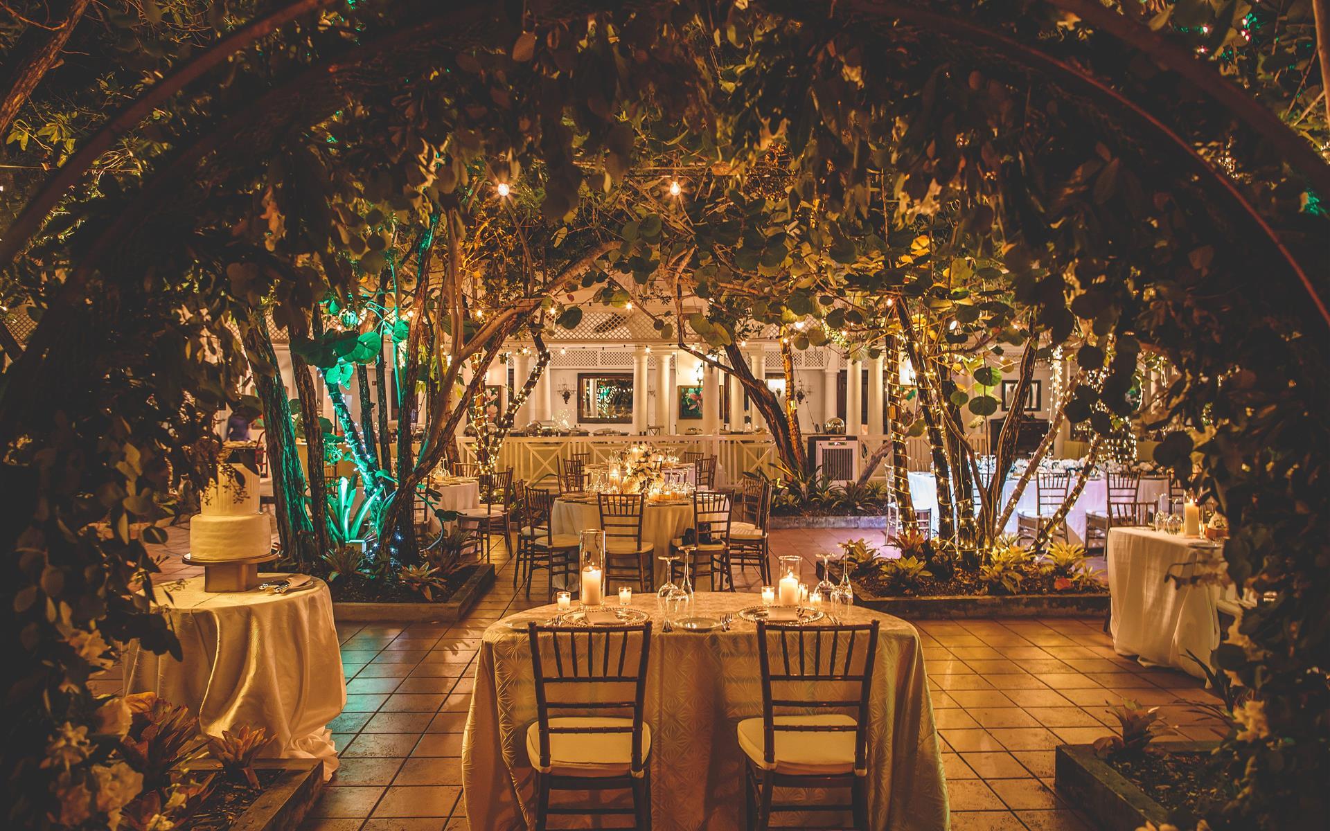 Seagrape Terrace with an arched entryway of greenery and soft lighting