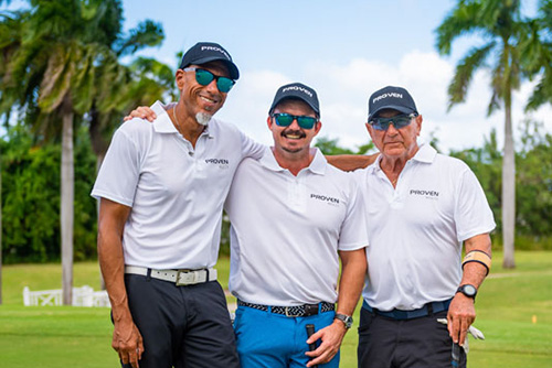 Three guys smiling for a picture in white collared shirts