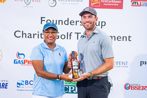 Golfer receiving a bottle of dark liquor