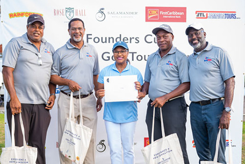 Four golfers receiving certificates and tote bags from Grey Goose