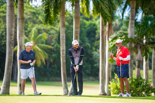 Guys smiling and laughing together in Digicell hats