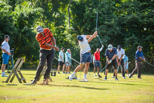 Golfers practicing at a driving range