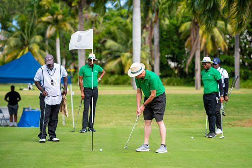 CPJ Representatives in Bacardi hats on the green