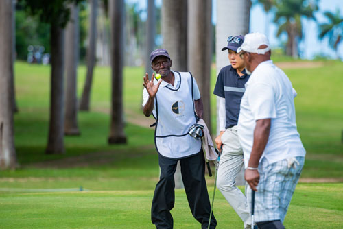 Half Moon worker catching a yellow golf ball