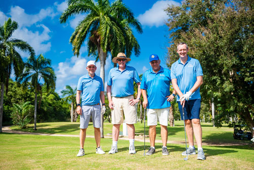 Golfers smiling together in blue uniforms