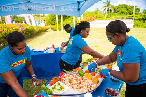 Rainforest food booth with shrimp, bell peppers, sauce, and more