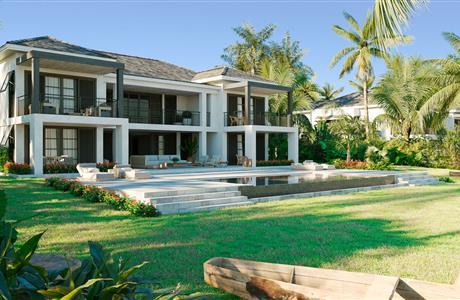 A beach with buildings and a pool