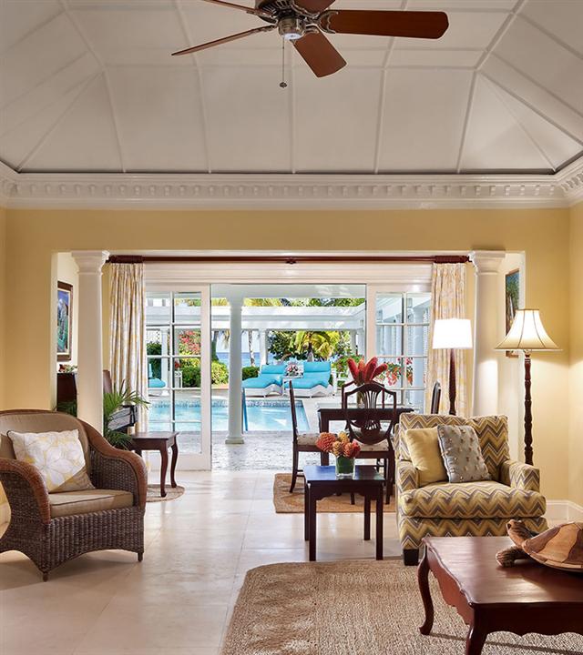 A living room with a fan and chairs