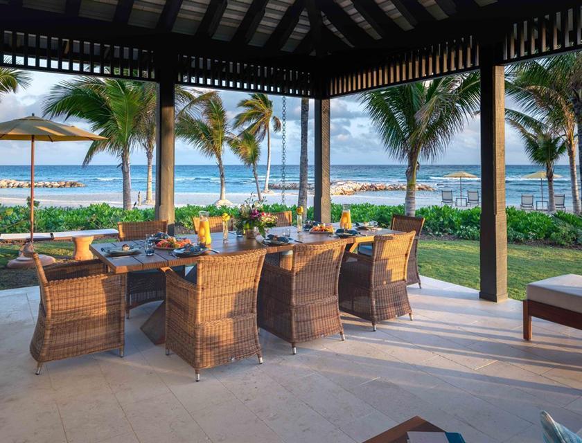 A table set up on a patio overlooking the ocean