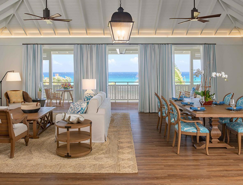 A living room with a large table and chairs