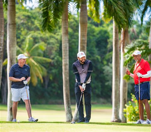 A group of men standing on a golf course